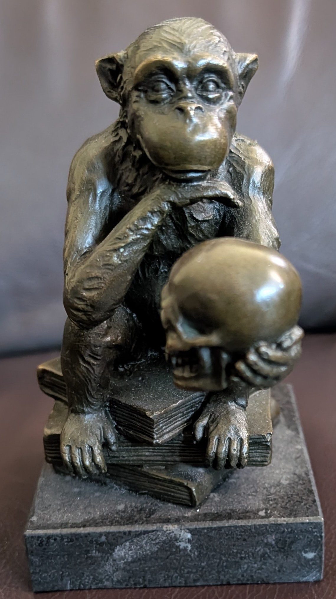 Image for Bronze Philosophizing Monkey Holding A Skull Seated Upon Books . Bronze Philosophizing Monkey Holding A Skull Seated Upon Books .